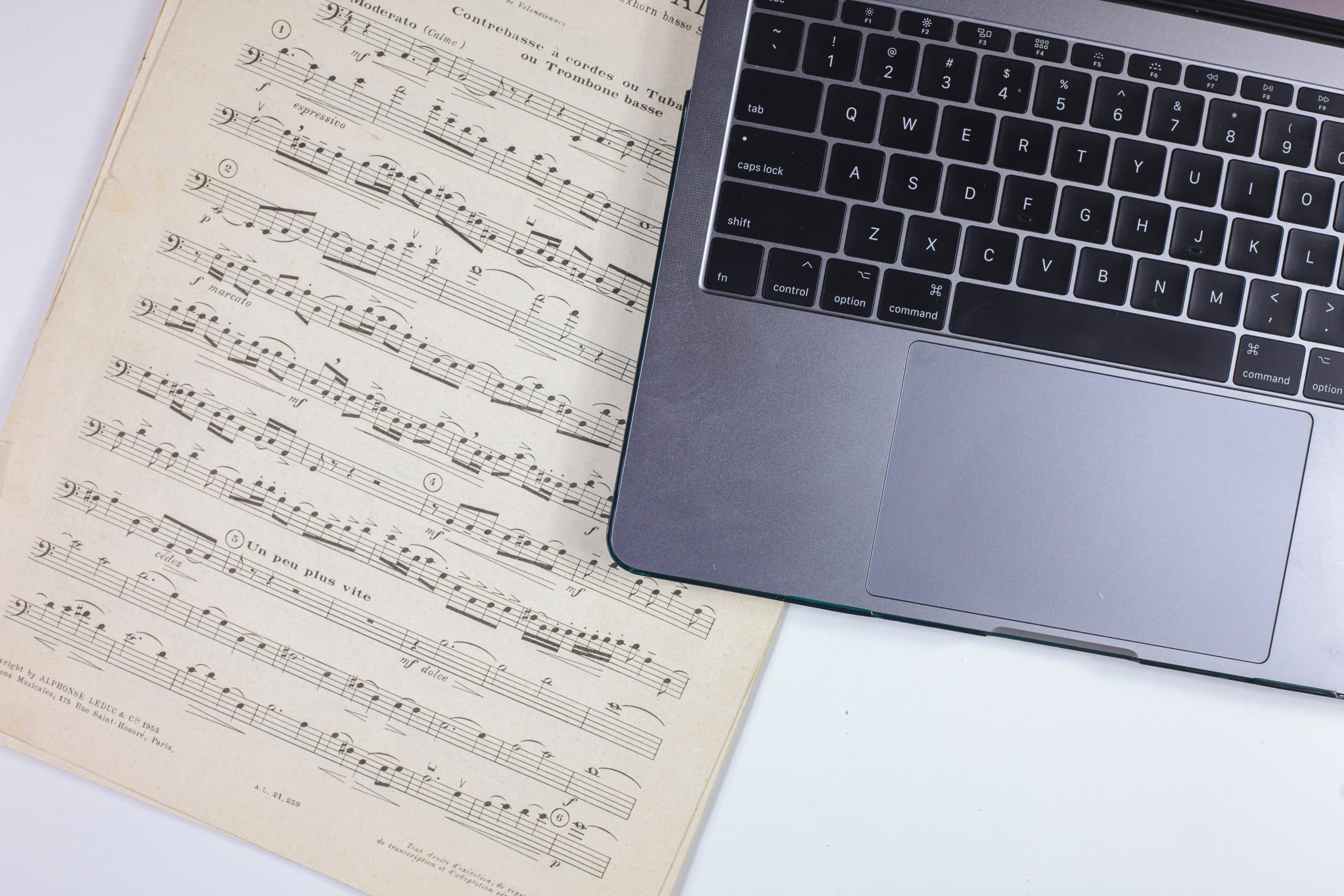 The Best Filmmaking Blogs in 2021 - An image of a musical score next to.a laptop