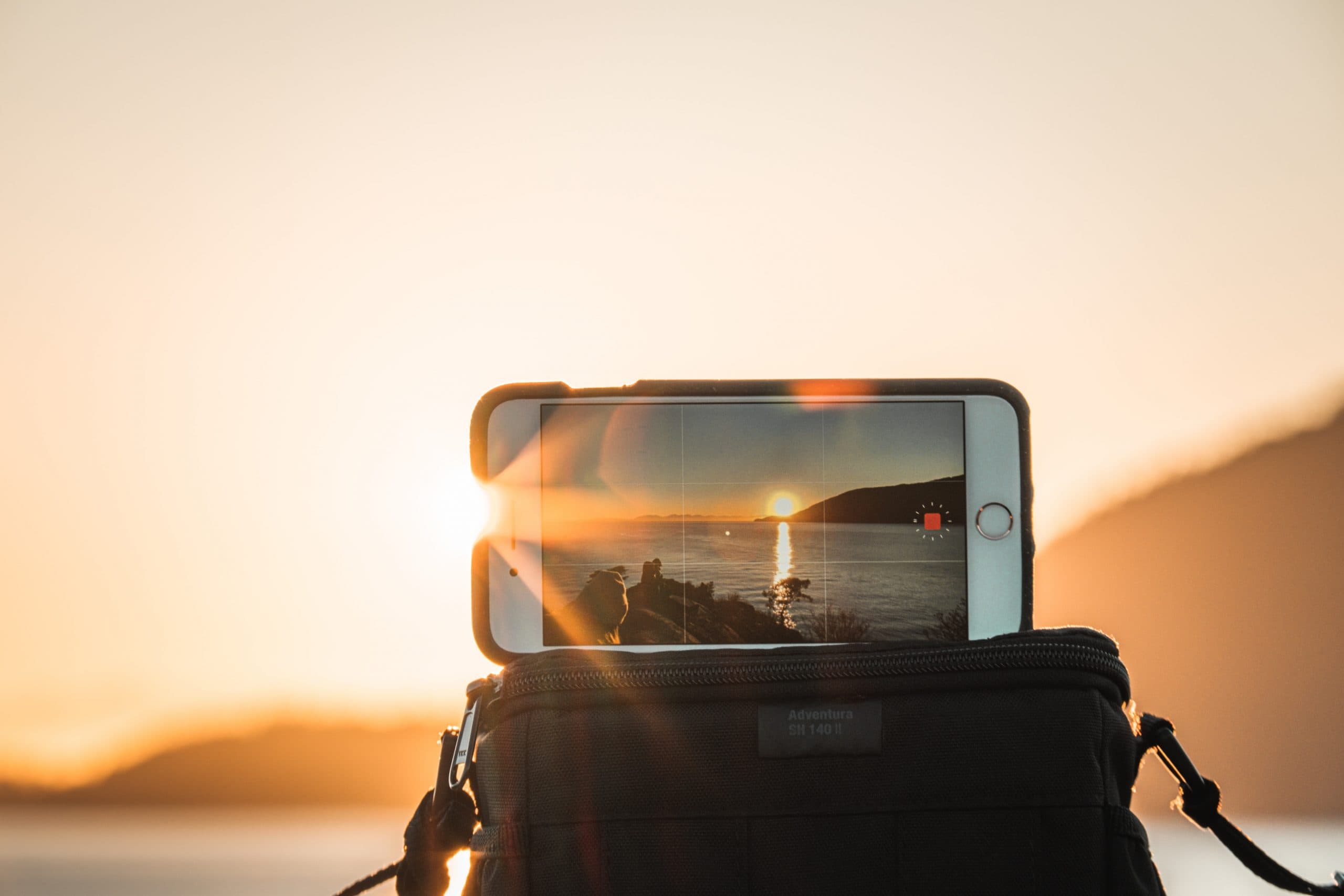 The Best Filmmaking Blogs in 2021 - An image of an iPhone filming a sunset