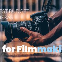 Best budget cameras for filmmaking - man holding camera