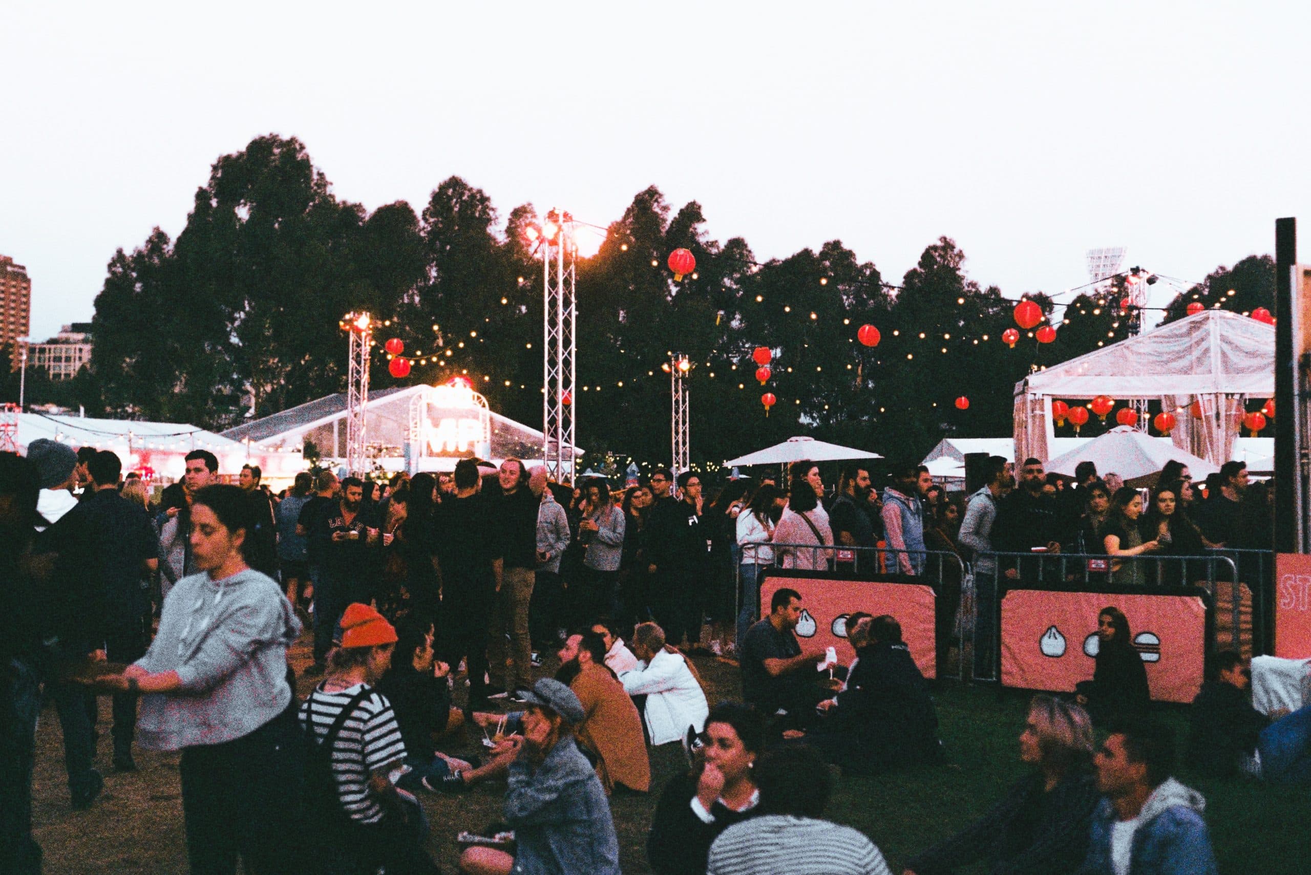 The Best Filmmaking Blogs in 2021 - An image of people sitting on the grass at a festival